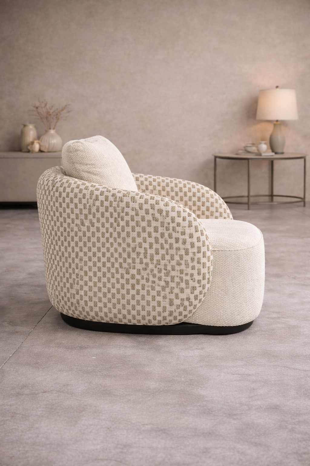 Luxury single seater lounge chair with curved design and soft fabric upholstery